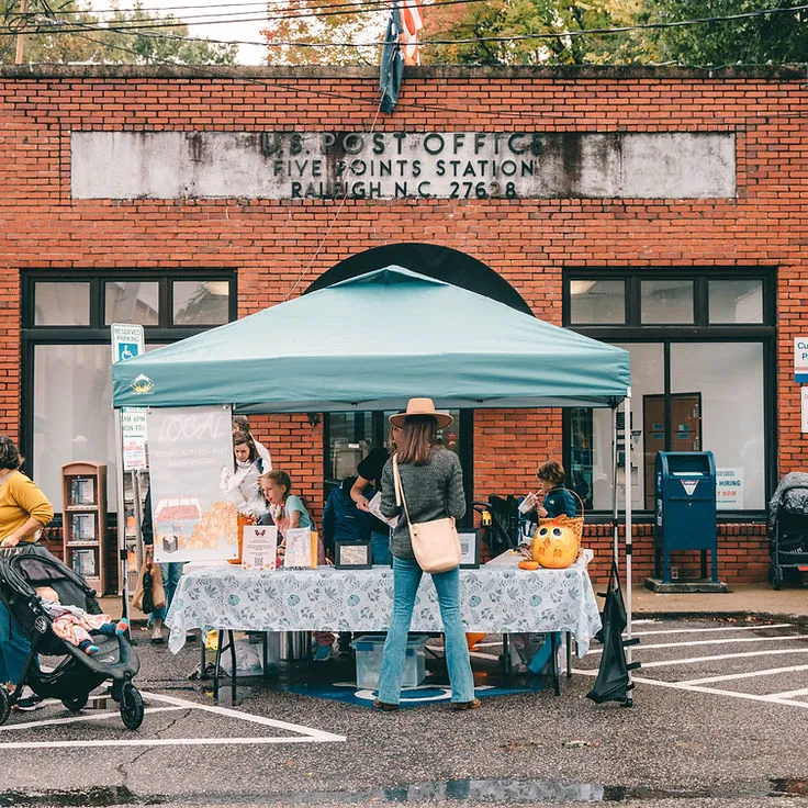 A woman shopping at a street vendor booth