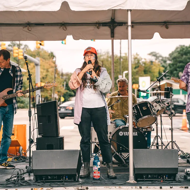 A woman shopping at a street vendor booth