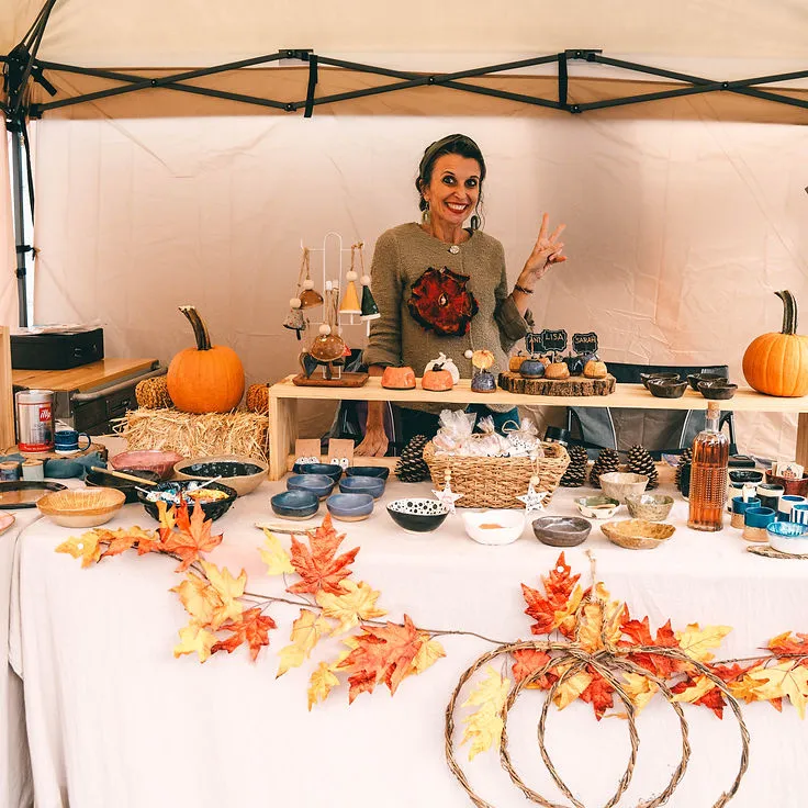 A woman shopping at a street vendor booth